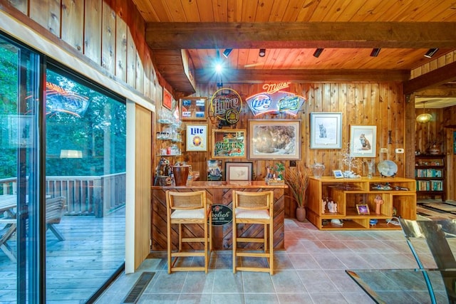 interior space with wooden ceiling, visible vents, beam ceiling, and tile patterned floors