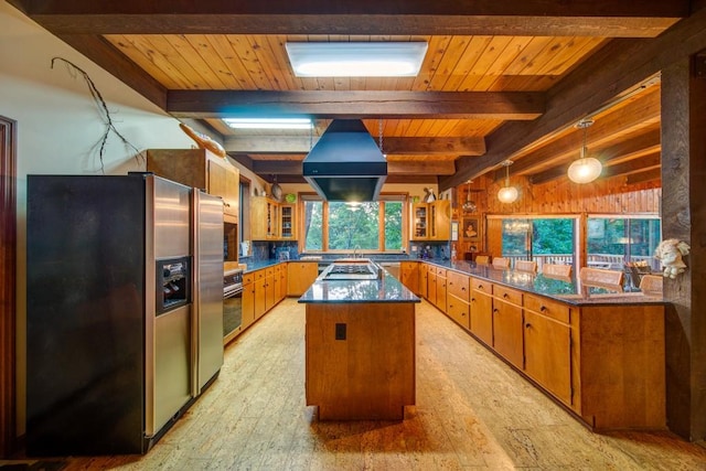 kitchen with island range hood, dark countertops, a kitchen island, glass insert cabinets, and stainless steel appliances