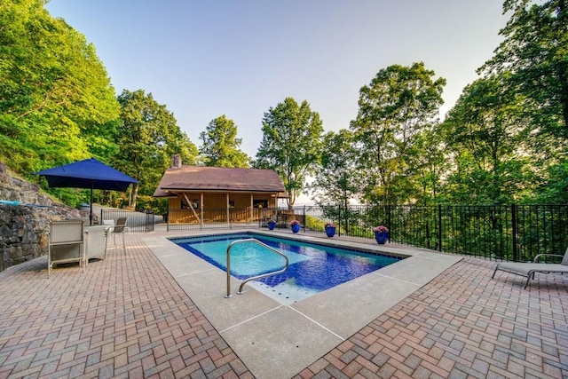 view of pool with a patio area, fence, and a fenced in pool