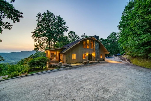 chalet / cabin with a mountain view and driveway