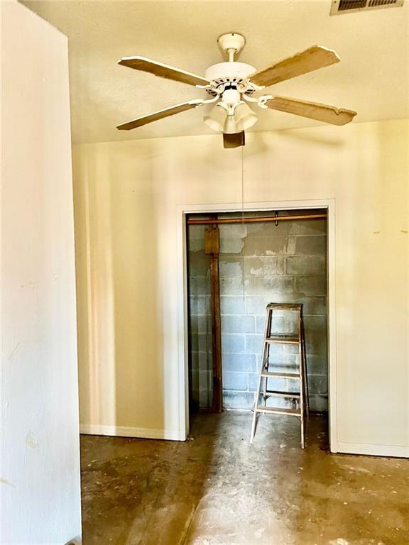 interior space with ceiling fan