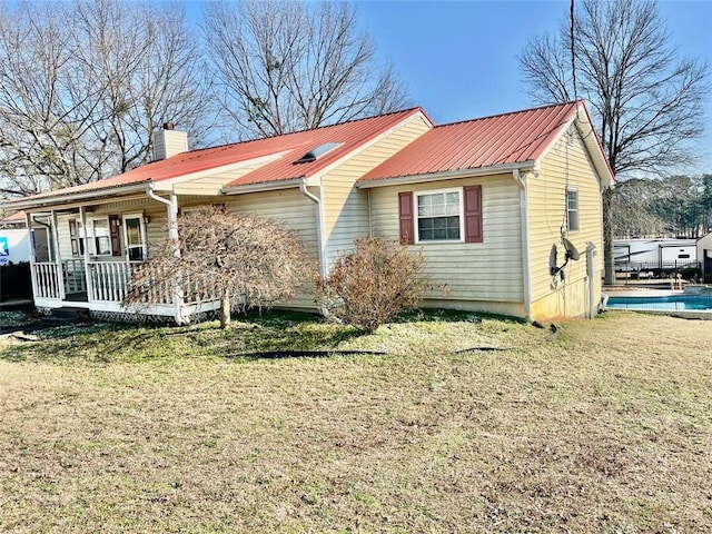 back of property featuring a porch and a lawn