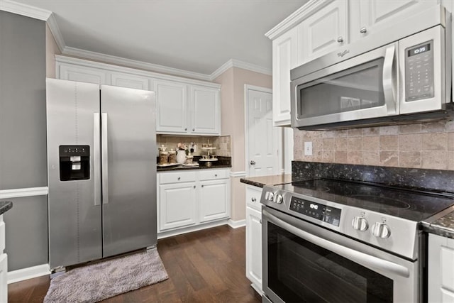 kitchen with stainless steel appliances, ornamental molding, and white cabinets