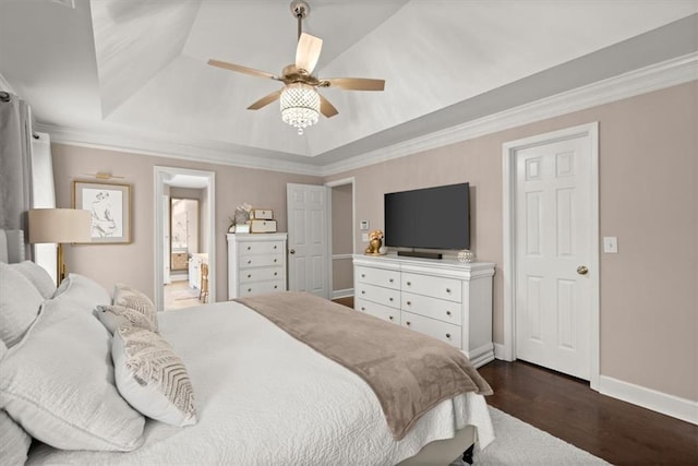 bedroom featuring dark wood-type flooring, ceiling fan, ensuite bathroom, ornamental molding, and a raised ceiling