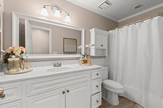 bathroom featuring vanity, ornamental molding, and toilet