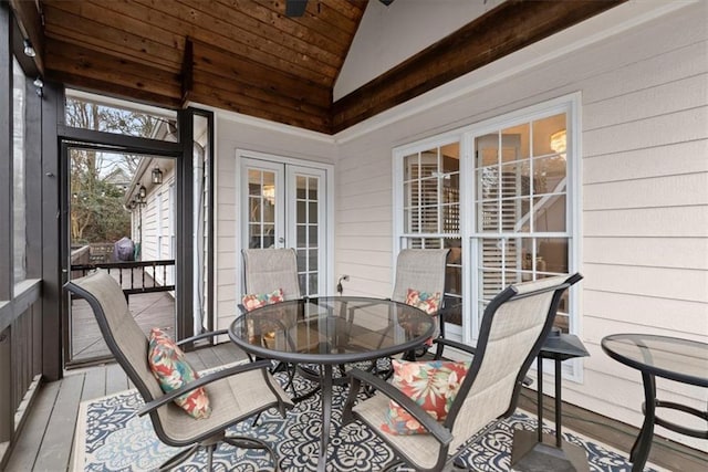 sunroom / solarium featuring lofted ceiling, wood ceiling, and french doors