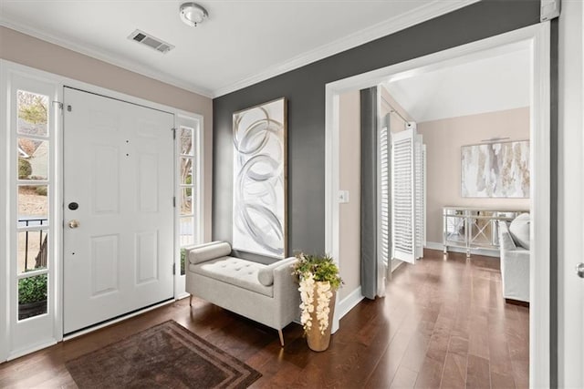 entryway featuring dark wood-type flooring, crown molding, and a wealth of natural light