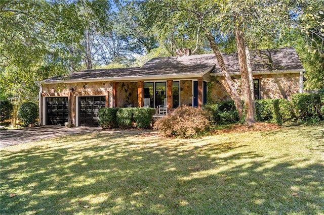 single story home featuring a front yard and a garage