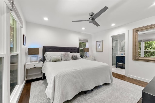 bedroom featuring ceiling fan, dark hardwood / wood-style flooring, and ensuite bath