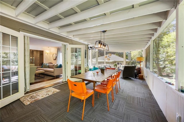 sunroom featuring beam ceiling