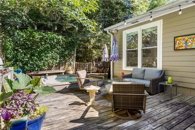 wooden deck featuring an outdoor hangout area