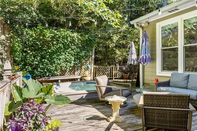 deck featuring an outdoor living space and pool water feature