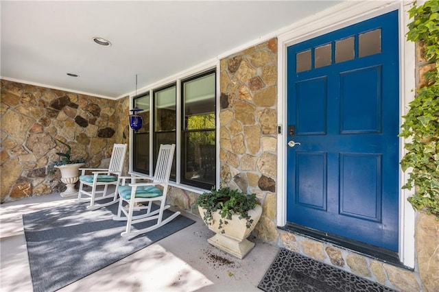 doorway to property featuring covered porch