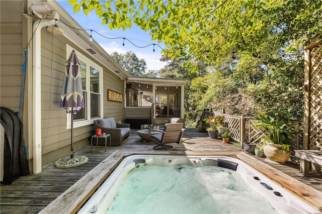 view of swimming pool featuring a deck and a sunroom