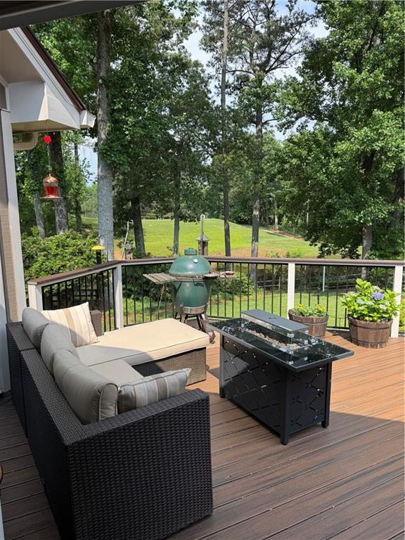 12162 Mountain Laurel Dr, Roswell, GA 30075 - wooden deck with an outdoor hangout area, view of scattered trees, and area for grilling