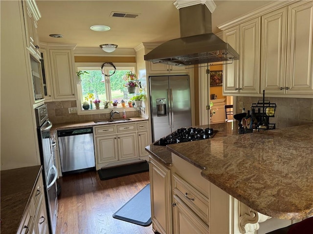 12162 Mountain Laurel Dr, Roswell, GA 30075 - kitchen featuring wall chimney range hood, appliances with stainless steel finishes, a sink, decorative backsplash, and dark wood-type flooring