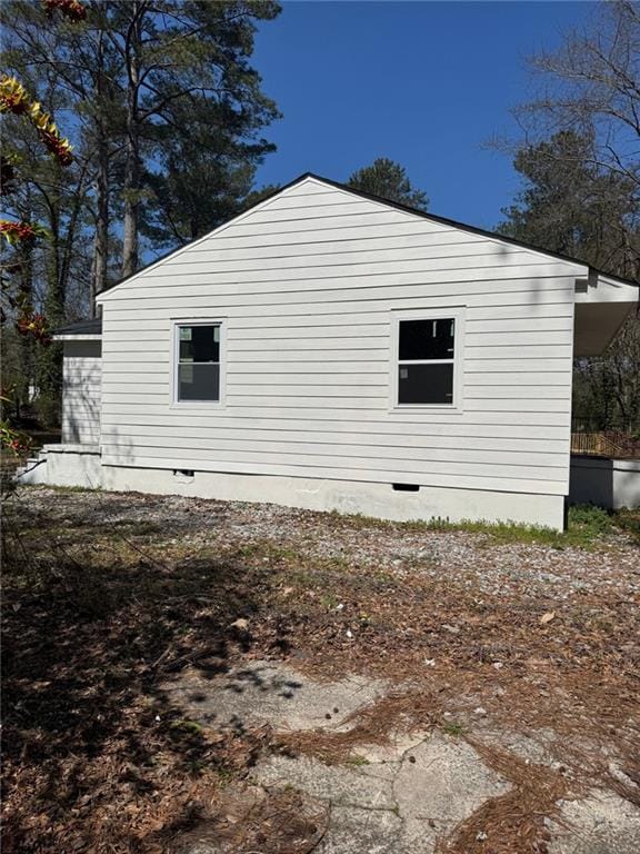 view of property exterior with crawl space