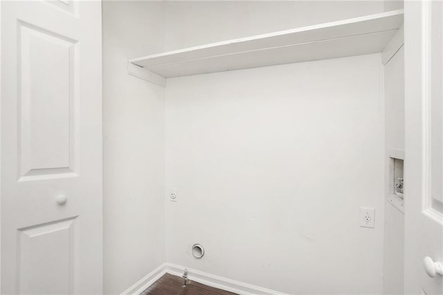 clothes washing area featuring hookup for a washing machine, hookup for an electric dryer, dark wood finished floors, and baseboards