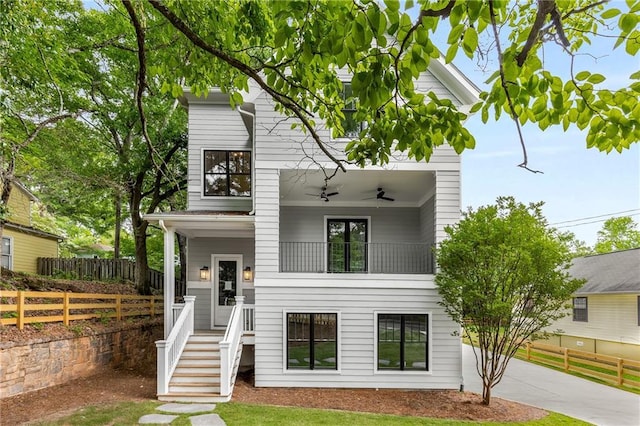 view of front of home featuring ceiling fan, covered porch, and a balcony