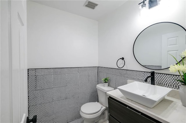 bathroom featuring toilet, tile patterned flooring, and vanity