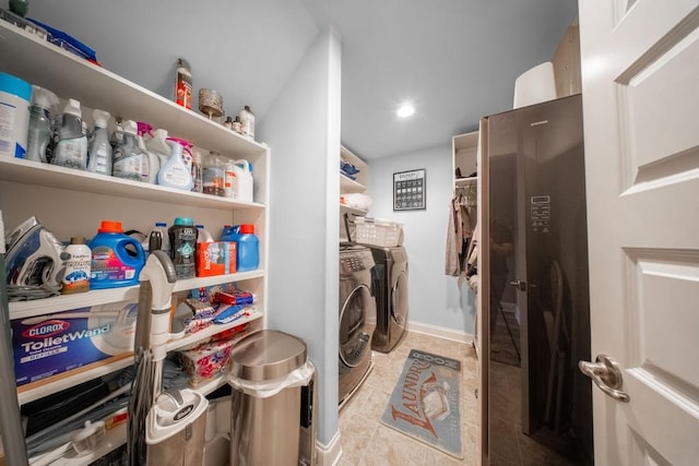 laundry room featuring light tile patterned flooring and washing machine and clothes dryer