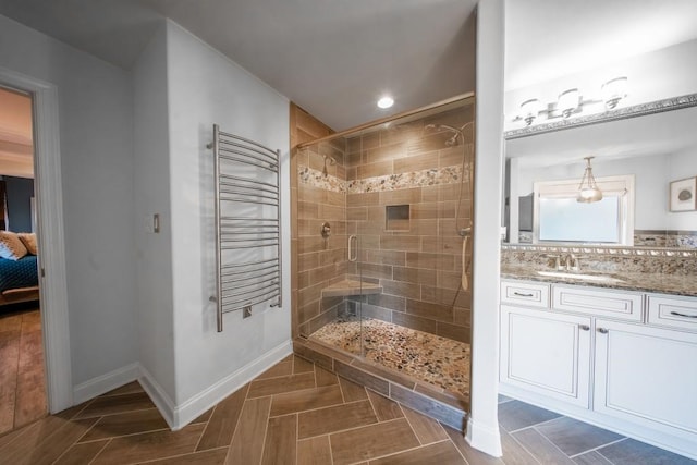 bathroom featuring an enclosed shower, backsplash, vanity, and radiator heating unit