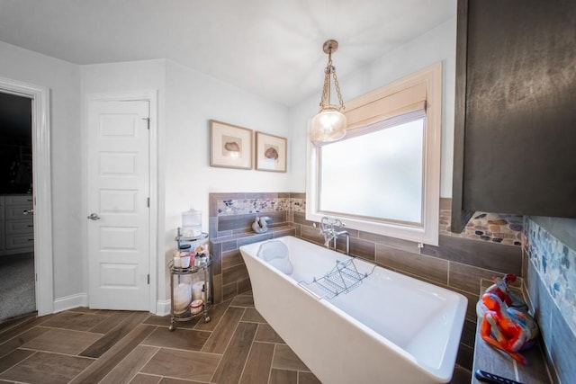 bathroom featuring tile walls and a tub