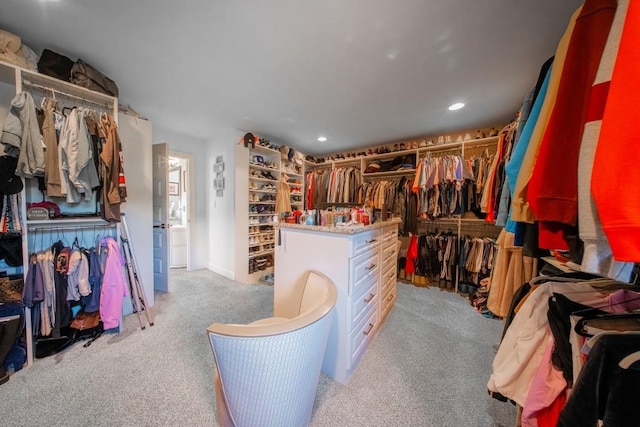 walk in closet with light carpet