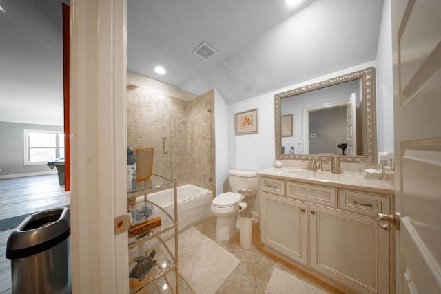 full bathroom with tiled shower / bath combo, vanity, and toilet