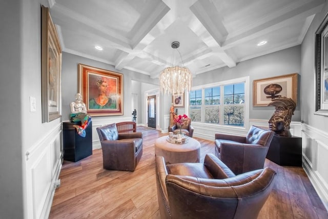 sitting room featuring ornamental molding, coffered ceiling, beam ceiling, and light wood-type flooring