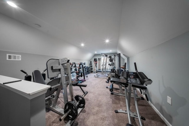 exercise room with vaulted ceiling and carpet