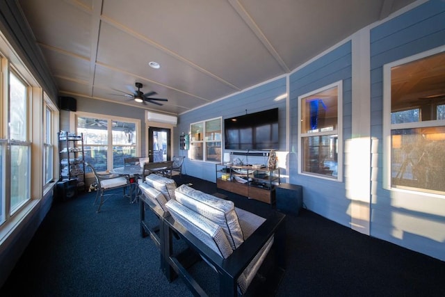 sunroom featuring ceiling fan and an AC wall unit