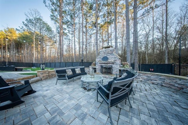 view of patio / terrace featuring an outdoor living space with a fireplace