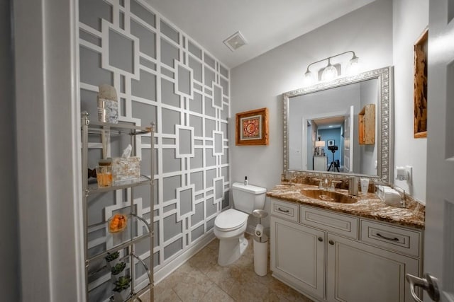 bathroom featuring vanity, toilet, and tile patterned flooring