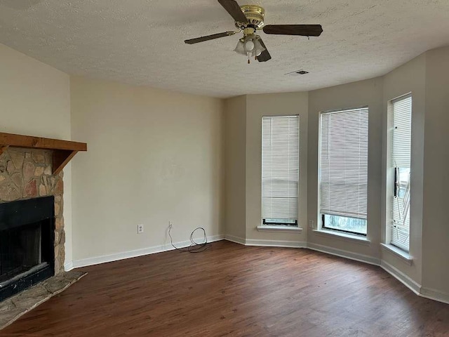 unfurnished living room with wood finished floors, a fireplace, and baseboards