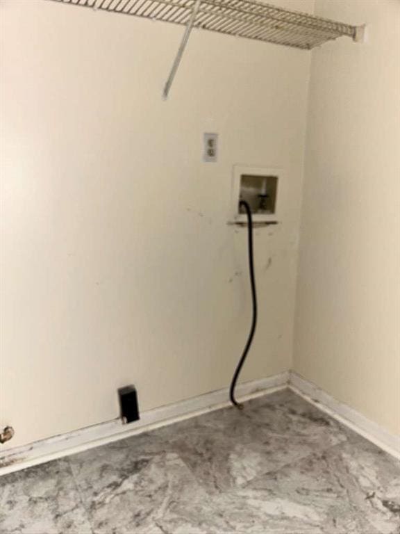 laundry area with laundry area, baseboards, and washer hookup