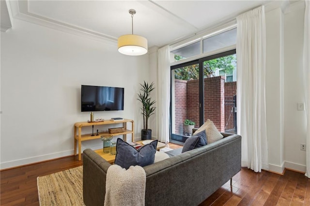 living area featuring hardwood / wood-style flooring and baseboards