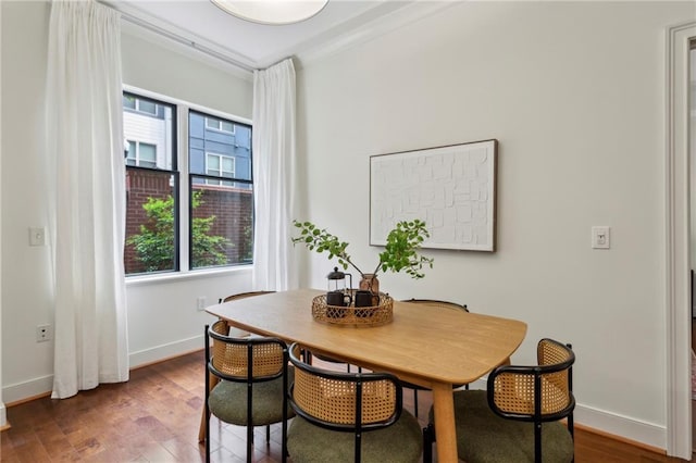 dining space with wood finished floors and baseboards