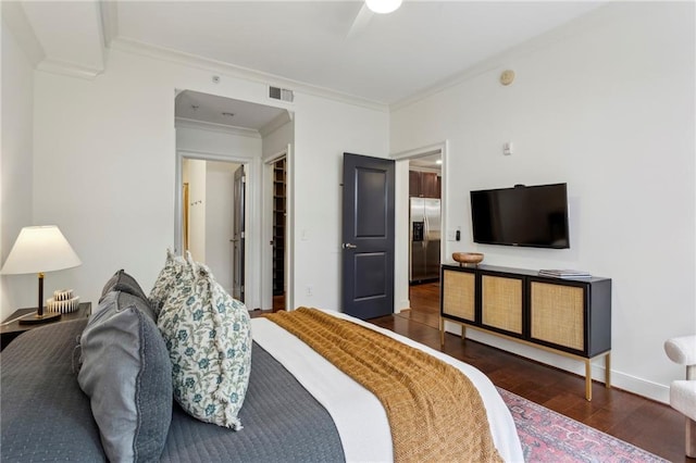 bedroom featuring stainless steel fridge with ice dispenser, wood finished floors, crown molding, and baseboards