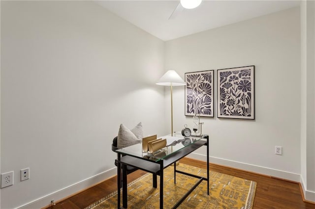 office featuring baseboards, wood finished floors, and a ceiling fan