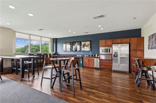 dining room with dark wood-style flooring and recessed lighting