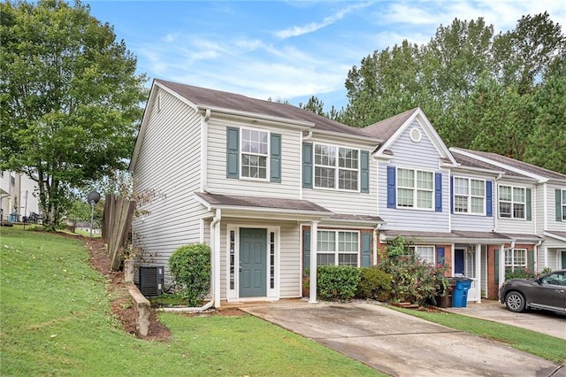 view of front of home with a front yard and central air condition unit