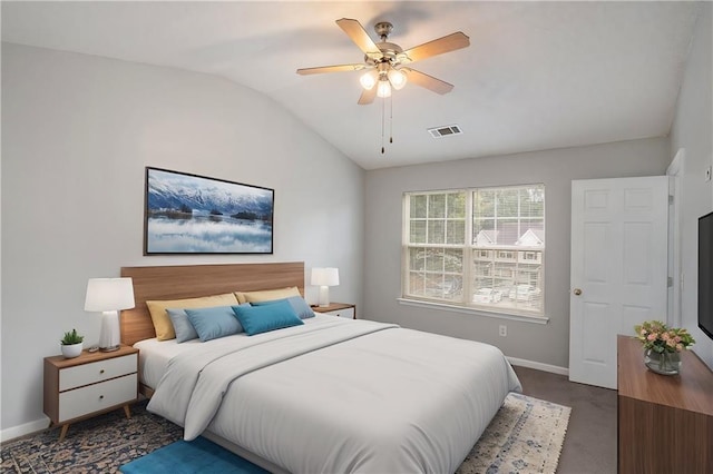 carpeted bedroom with ceiling fan and vaulted ceiling