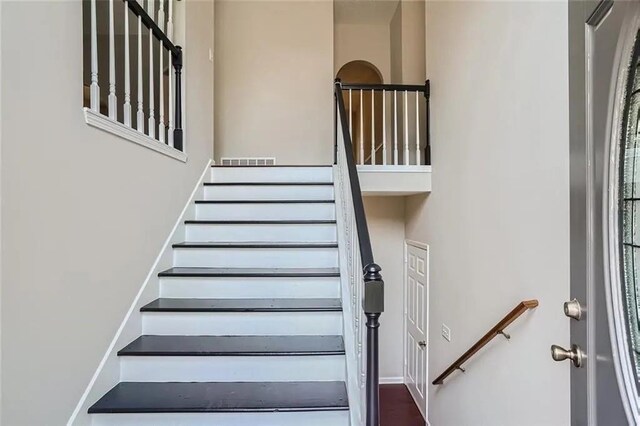 stairs featuring a towering ceiling