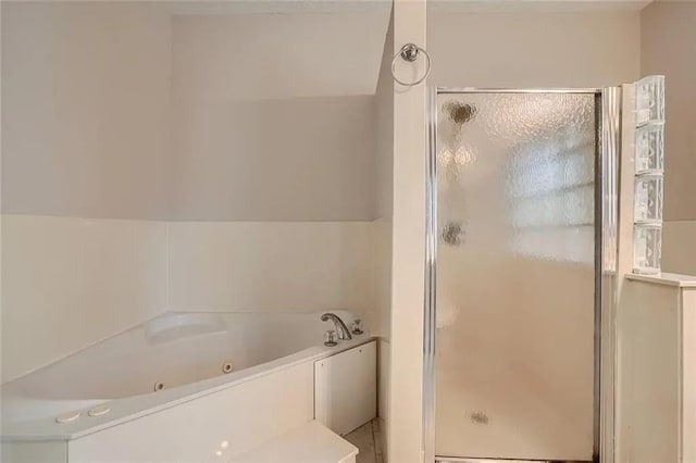 bathroom with lofted ceiling and shower with separate bathtub