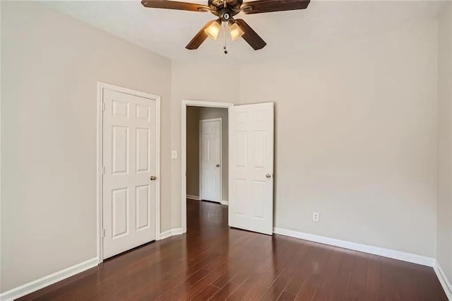 unfurnished bedroom featuring dark hardwood / wood-style flooring and ceiling fan