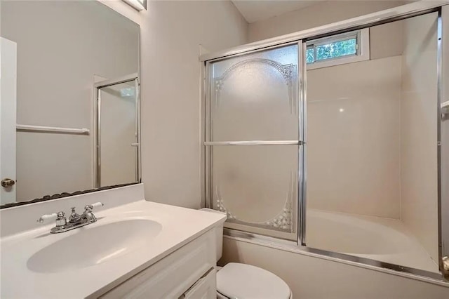 full bathroom featuring shower / bath combination with glass door, vanity, and toilet