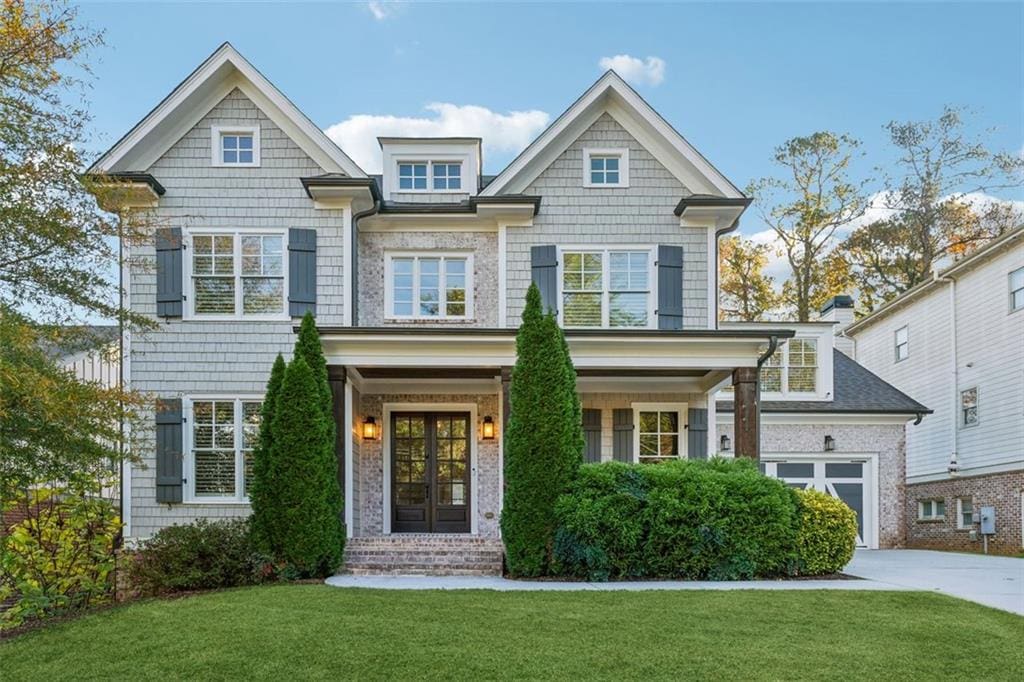 4333 Rickenbacker Way NE, Atlanta, GA 30342 - view of front of house with french doors, an attached garage, concrete driveway, and a front yard