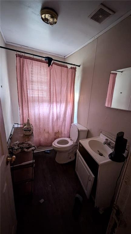 bathroom featuring wood-type flooring, curtained shower, toilet, vanity, and ornamental molding