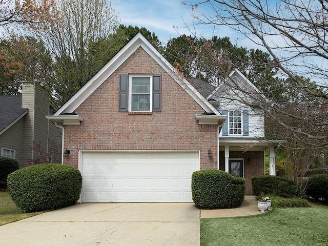 traditional home with brick siding, a front lawn, concrete driveway, and an attached garage